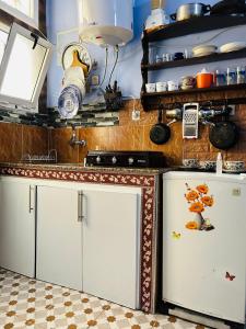 a kitchen with two white refrigerators in a room at Casa Inas in Chefchaouene