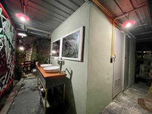 a bathroom with three sinks in a room at PhuketAirportCamping in Mai Khao Beach