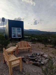 a backyard with two benches and a fire pit at Montana in Potrerillos +6 photos