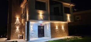 a house with a front door lit up at night at فيلا مستقلة 5 غرف مطلة على البحر - منتجع بلو باي اسيا السخنة Villa Blue bay Asia Sokhna in Ain Sokhna