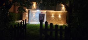 a house with a fence in front of it at night at فيلا مستقلة 5 غرف مطلة على البحر - منتجع بلو باي اسيا السخنة Villa Blue bay Asia Sokhna in Ain Sokhna