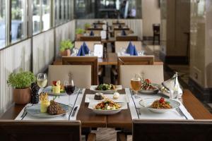 a table with plates of food and glasses of wine at Titanic City Taksim in Istanbul