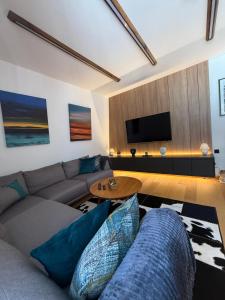 a living room with a couch and a table at Una Carpa Jahorina in Jahorina