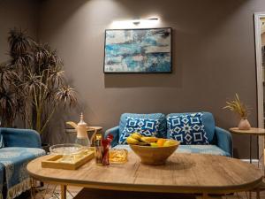 a living room with a table with a bowl of fruit at شقة فندقية غرفتين وصالة in Al Madinah +22 photos