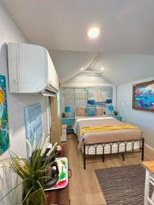 a bedroom with a bed in a room at Stylish Retreat Walk 2Dtwn Bikes l Patio l Beach in St Petersburg