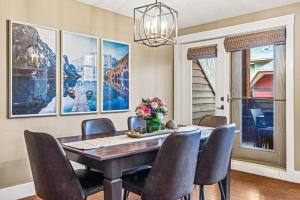 a dining room with a table and chairs at Cozy 2BR Retreat Mountain View with Pool and Hot Tub in Canmore