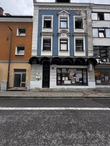 a blue and white building on a city street at Aby Wohnungen in Rosenheim