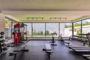 a gym with a lot of treadmills and machines at Elegant 3BR Condo Near Airport in Punta Cana