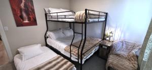 a room with two bunk beds and a bed at Hot Tub, Kayaks, Game Room, Boat Parking, Fire Pit, King, WD in Page