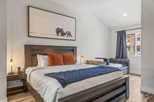 ein Schlafzimmer mit einem großen Bett und einem Bild von Elefanten in der Unterkunft Mountain View Penthouse with Pool and Hot Tub in Canmore