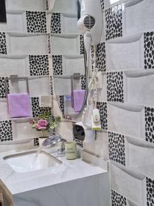 a bathroom with a sink and a blow dryer at Seckebe Immo SUITE 1 in Dakar