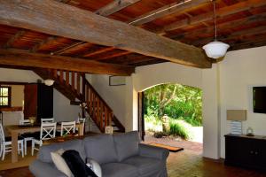 a living room with a couch and a dining room at The Barn in Bangalow