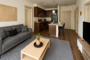 a living room with a couch and a table at Central Birmingham Stylish Midrise Unit in Birmingham