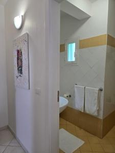 a white bathroom with a sink and a mirror at Soul of Sal in Santa Maria