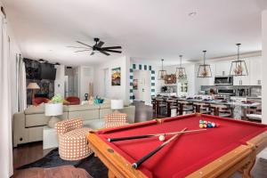 a living room with a pool table and a kitchen at The Poconest - Luxurious Mountain Mansion in Long Pond