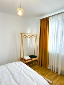a bedroom with a bed with a swing and a window at Cabana Vatra Sloveanu 