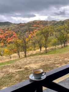 a cup of coffee sitting on top of a table at Cabana Vatra Sloveanu  +4 photos