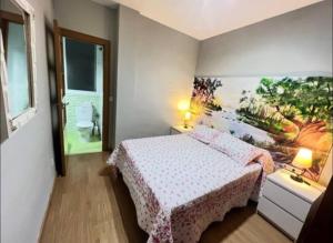 a bedroom with a bed and a painting on the wall at Mar y Sol Almuñécar Apartment in Almuñécar