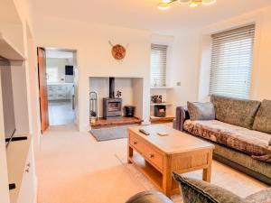 a living room with a couch and a coffee table at Tollbar Cottage in Penrith