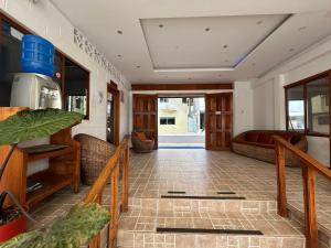 a living room with a staircase and a couch at Hotel Mar Azul in Puerto Baquerizo Moreno