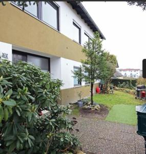 a house with a tree in front of it at WG-Zimmer-Erstbezug nach Sanierung -Vollmöbliert in Taunusstein
