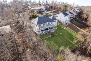 an aerial view of a large house with a yard at Lakeside Retreat - Large Deck & Game Room with Views in Bland