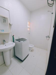 a white bathroom with a sink and a toilet at هومي 2 in Salalah +28 photos