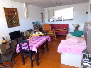 una sala de estar con una mesa y un sofá en Vicos, en Esquel