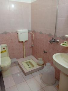 a bathroom with a toilet and a sink at Balakot International Hotel in Dargai