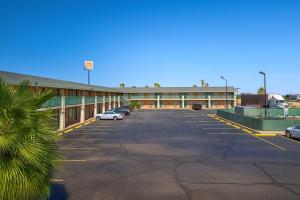 a parking lot in front of a large building at MHO Hotel Eloy Casa Grande Near I-10 in Eloy
