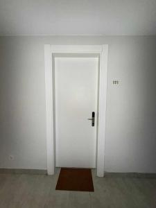 a white door in a room with a brown rug at Apartment N111 Loft 2 in Gudauri