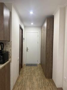 a hallway with a white door and wooden cabinets at Apartment N111 Loft 2 in Gudauri