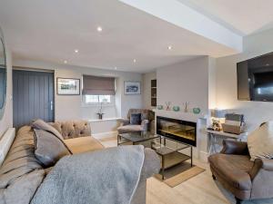 a living room with a couch and a fireplace at 2 Bed in Cartmel 73154 in Cartmel