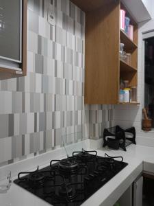 a kitchen with a stove top oven in a kitchen at AP COP 30 com Garagem em Cond in Marituba