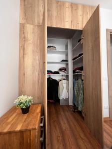 a walk in closet with a large wooden door at Timeless Comfort in Sfântu-Gheorghe