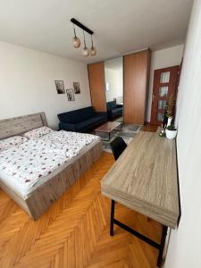 a bedroom with a bed and a table in it at SimpleStay with parking in Košice
