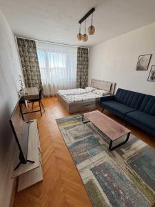 a living room with a couch and a bed at SimpleStay with parking in Košice