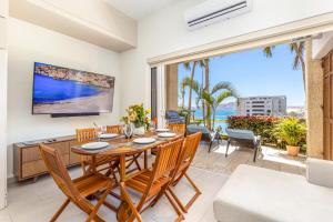 a dining room with a table and chairs at Beachfront luxury Condo w Pool in Cabo San Lucas