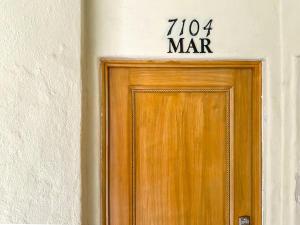 a wooden door with a sign above it at Beachfront luxury Condo w Pool in Cabo San Lucas +23 photos