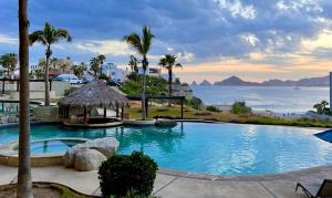 a swimming pool with a view of the ocean at Beachfront luxury Condo w Pool in Cabo San Lucas