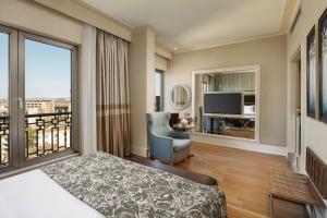 a bedroom with a bed and a large window at Titanic City Taksim in Istanbul