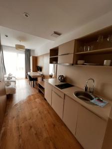 a kitchen with a sink and a table in a room at Warsoliv double 304 in Warsaw