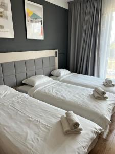 two beds sitting next to each other in a bedroom at Warsoliv double 304 in Warsaw