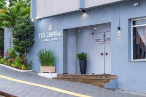 a blue building with the front door of a fcu central first aid at Foz Central Budget Hotel in Foz do Iguaçu