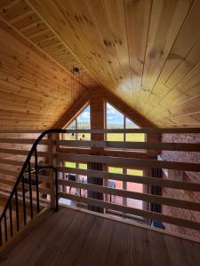 a room with a wooden ceiling and a staircase at Beskid Barns - Domek z Balią i Widokiem na Babią Górę in Jordanów +10 photos