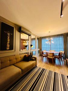 a living room with a couch and a table at Vita Boulevard Gramado in Gramado