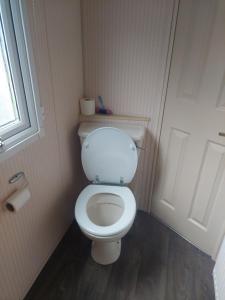 a bathroom with a white toilet in a room at The Raven in Silloth