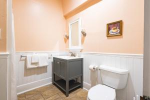a bathroom with a toilet and a sink at Creme Brulee Suite in Key West