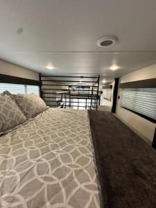 a bedroom with a large bed in a house at Buffalo Drift Tiny Home in Interior +12 photos