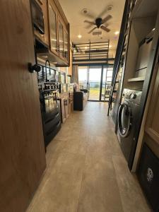 a hallway of an rv with a washer and dryer at Buffalo Drift Tiny Home in Interior